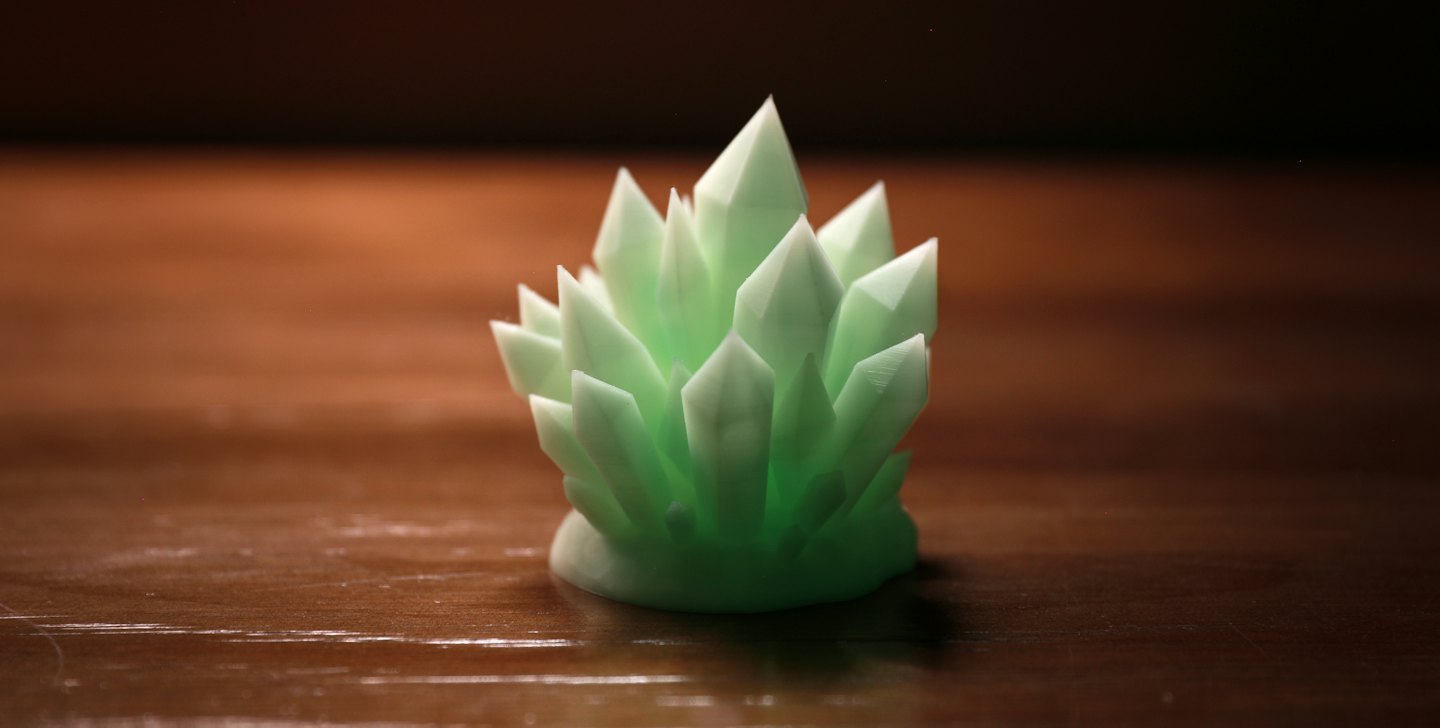 Light green crystal shapes on textured wood.